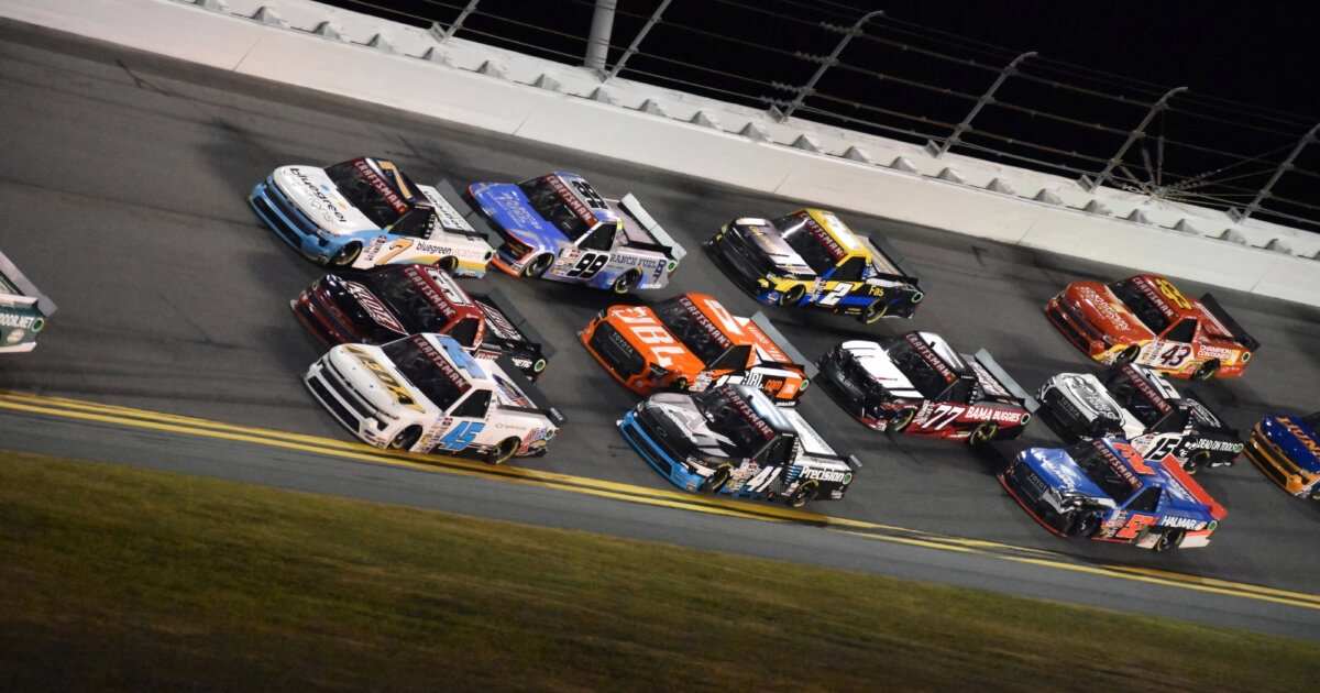 NASCAR stock cars racing on a track.